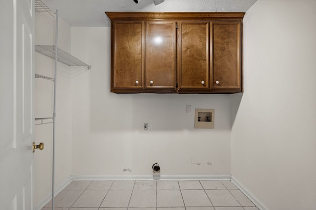 laundry area with electric dryer hookup, cabinet space, baseboards, hookup for a washing machine, and light tile patterned flooring