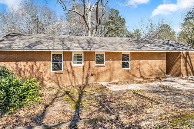 view of home's exterior with brick siding