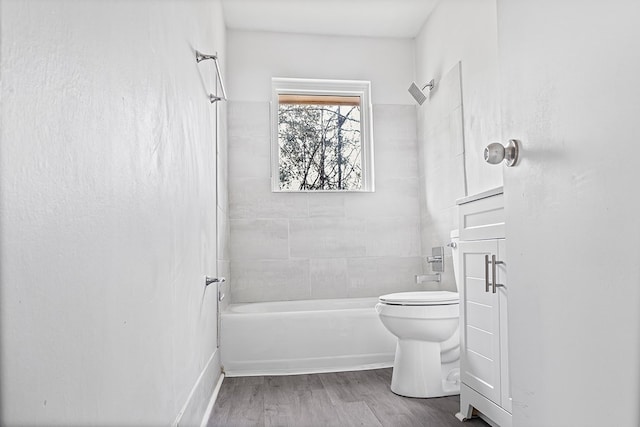 full bath featuring toilet, wood finished floors, and bathing tub / shower combination