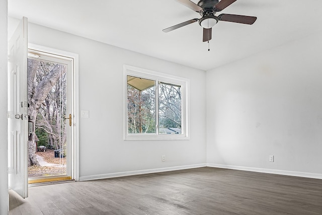 empty room featuring ceiling fan, wood finished floors, and baseboards