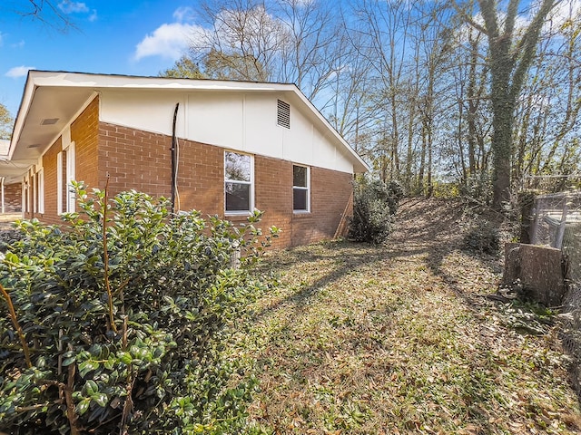 view of side of home featuring brick siding