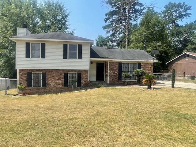 4200 Curry St, Columbus, GA 31907 - split level home with a chimney, a gate, and brick siding
