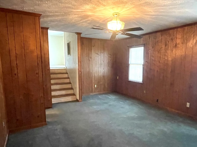4200 Curry St, Columbus, GA 31907 - carpeted spare room featuring a ceiling fan, wood walls, and stairs