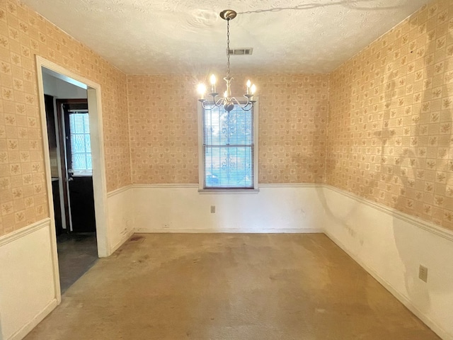 4200 Curry St, Columbus, GA 31907 - unfurnished dining area featuring wainscoting, healthy amount of natural light, a chandelier, a textured ceiling, and wallpapered walls