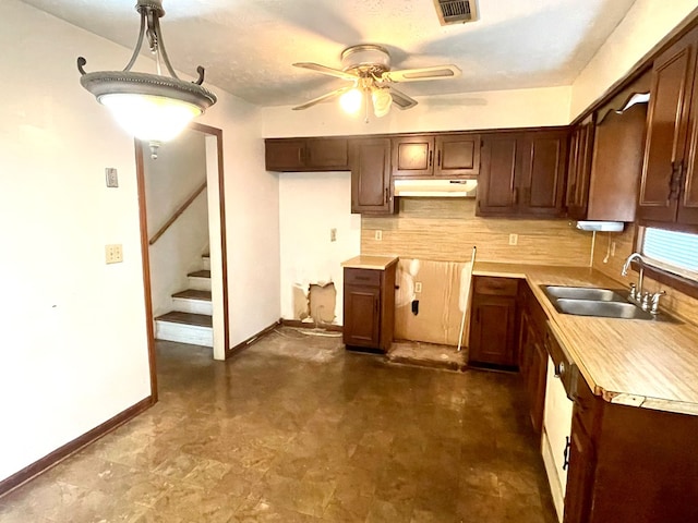 4200 Curry St, Columbus, GA 31907 - kitchen with under cabinet range hood, ceiling fan, backsplash, light countertops, and dark floors