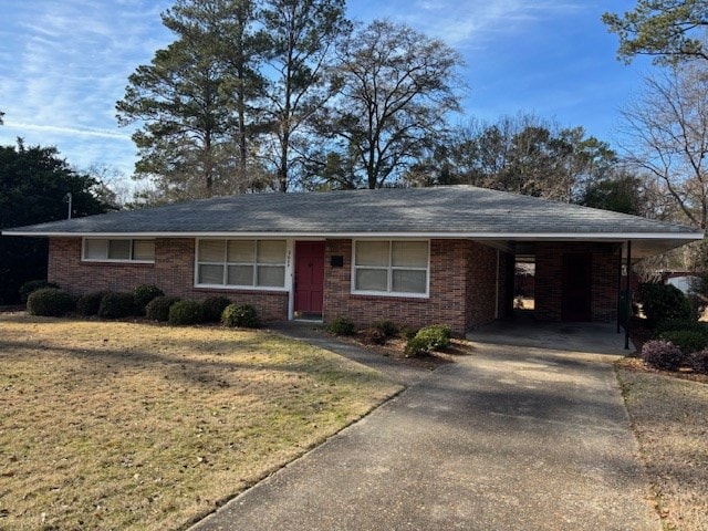 ranch-style home with a front yard and a carport