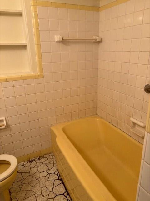 bathroom with toilet, tile patterned floors, and  shower combination