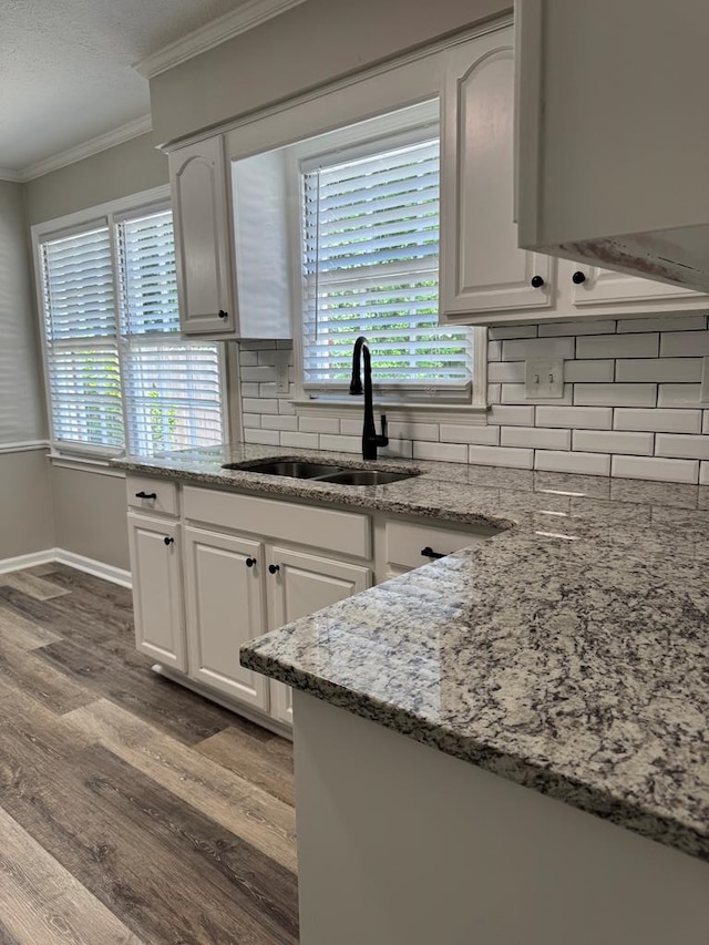4901 Willowbrook Dr, Columbus, GA 31909 - kitchen with ornamental molding, tasteful backsplash, wood finished floors, light stone countertops, and white cabinets