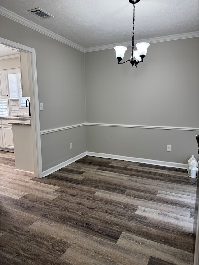 4901 Willowbrook Dr, Columbus, GA 31909 - unfurnished room with dark wood-type flooring, a chandelier, crown molding, and a textured ceiling