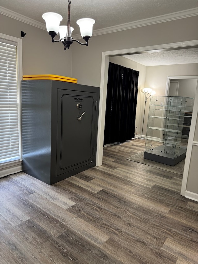 4901 Willowbrook Dr, Columbus, GA 31909 - unfurnished dining area with a chandelier, wood finished floors, crown molding, and a textured ceiling