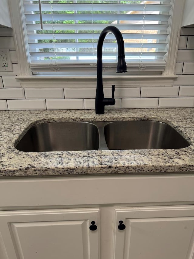 4901 Willowbrook Dr, Columbus, GA 31909 - kitchen view of tasteful backsplash, white cabinets, and light stone counters