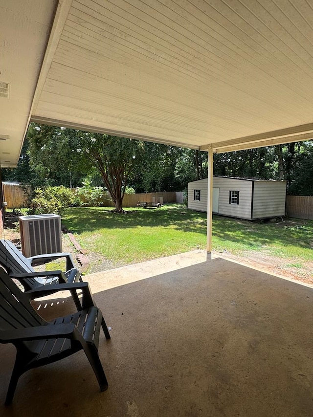 4901 Willowbrook Dr, Columbus, GA 31909 - fenced backyard featuring a patio area, an outdoor structure, and a carport