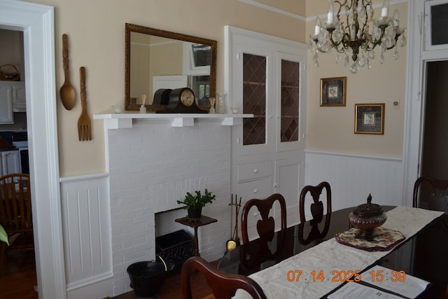 2901 Beacon Ave, Columbus, GA 31904 - dining area with a wainscoted wall, a chandelier, ornamental molding, and wood finished floors