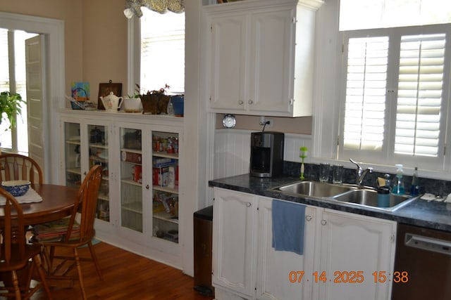 2901 Beacon Ave, Columbus, GA 31904 - kitchen featuring stainless steel dishwasher, healthy amount of natural light, dark countertops, and white cabinets