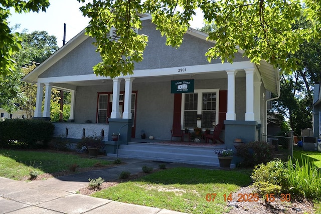 2901 Beacon Ave, Columbus, GA 31904 - view of front of house with covered porch, stucco siding, and a front yard