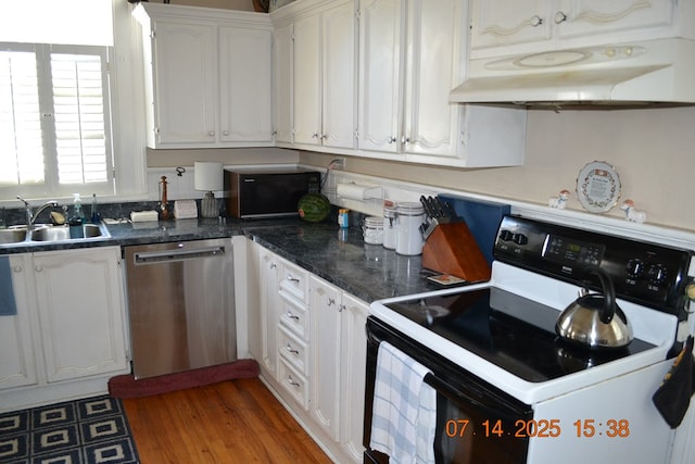 2901 Beacon Ave, Columbus, GA 31904 - kitchen with white electric stove, stainless steel dishwasher, under cabinet range hood, white cabinets, and dark countertops