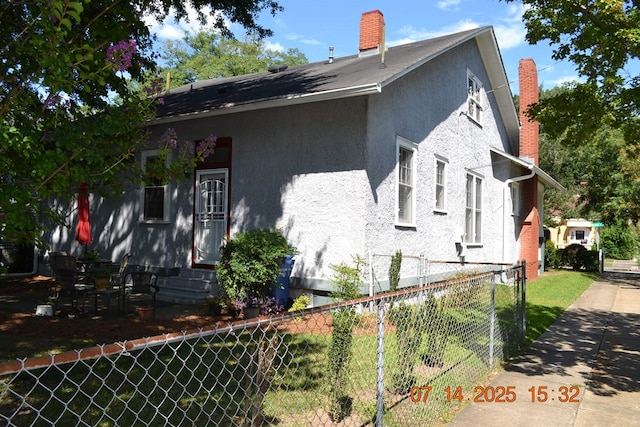 2901 Beacon Ave, Columbus, GA 31904 - view of side of property featuring a fenced front yard, stucco siding, a chimney, and entry steps