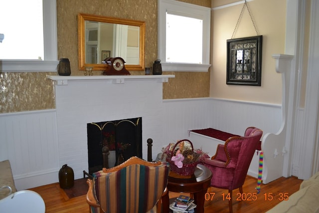 2901 Beacon Ave, Columbus, GA 31904 - living room with a wainscoted wall, plenty of natural light, wood finished floors, and a brick fireplace