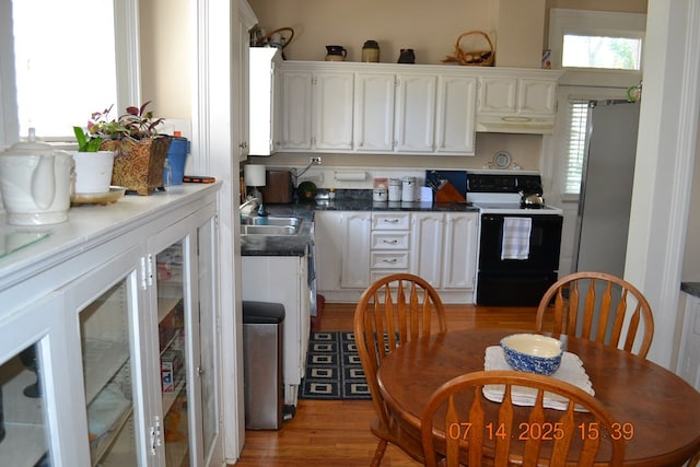 2901 Beacon Ave, Columbus, GA 31904 - kitchen featuring black / electric stove, white cabinetry, freestanding refrigerator, and dark countertops