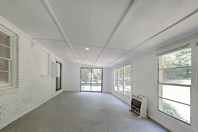 4657 Pate Dr, Columbus, GA 31907 - unfurnished room with baseboards, heating unit, brick wall, recessed lighting, and speckled floor