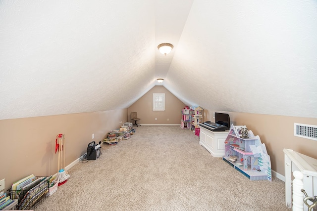 recreation room featuring visible vents, carpet floors, baseboards, and vaulted ceiling