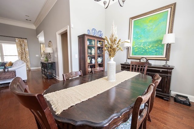 dining room with wood finished floors, baseboards, and ornamental molding