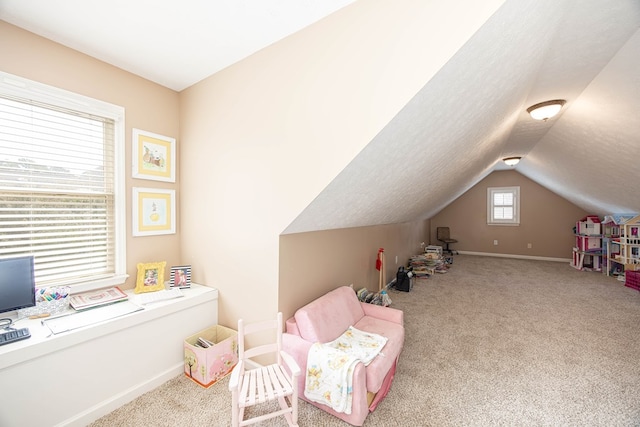 game room featuring vaulted ceiling, carpet flooring, baseboards, and a textured ceiling