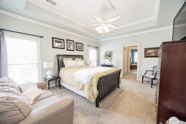 bedroom featuring visible vents, light carpet, crown molding, a raised ceiling, and ceiling fan