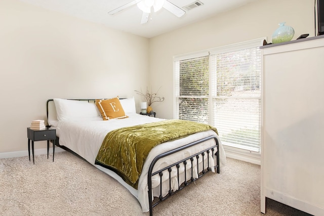 bedroom with visible vents, baseboards, carpet, and ceiling fan