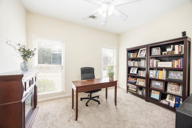 office space with visible vents, baseboards, carpet, and ceiling fan