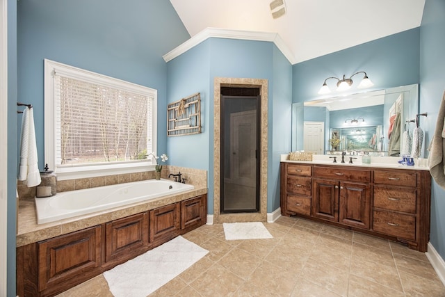 bathroom with a stall shower, tile patterned flooring, lofted ceiling, a bath, and vanity