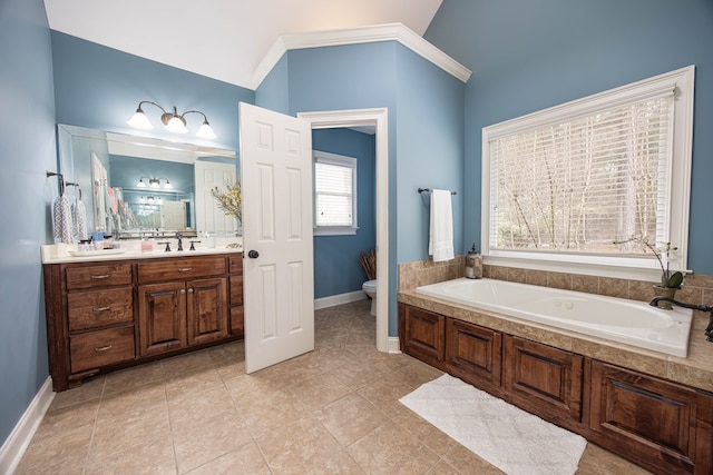 bathroom with baseboards, toilet, a garden tub, tile patterned floors, and vanity