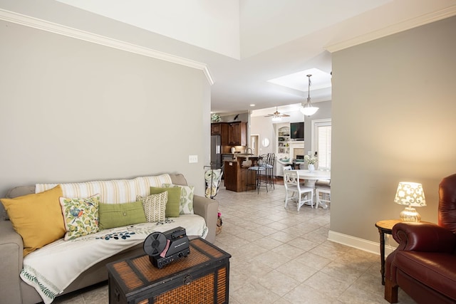 living room with light tile patterned floors, baseboards, a ceiling fan, and crown molding