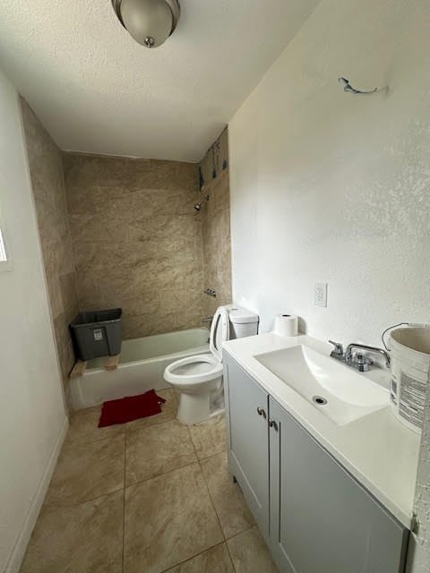 bathroom featuring toilet, tile patterned floors, bathtub / shower combination, a textured ceiling, and vanity