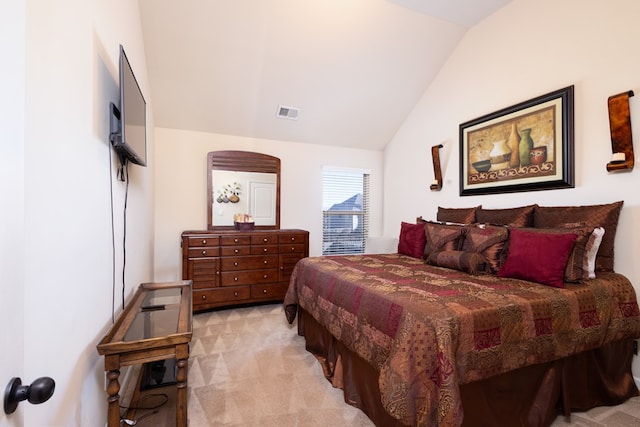 carpeted bedroom with vaulted ceiling