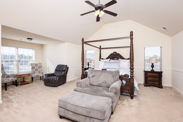 bedroom with ceiling fan, light colored carpet, and vaulted ceiling