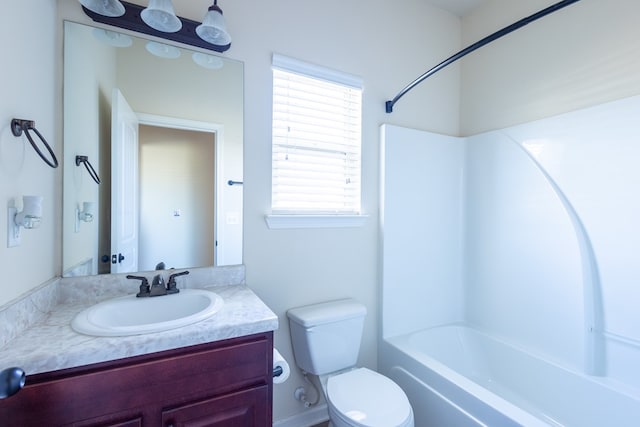 full bathroom with vanity, toilet, and  shower combination