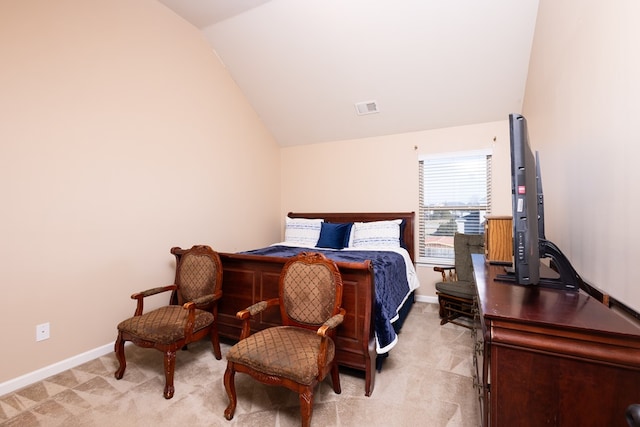 bedroom with light carpet and lofted ceiling