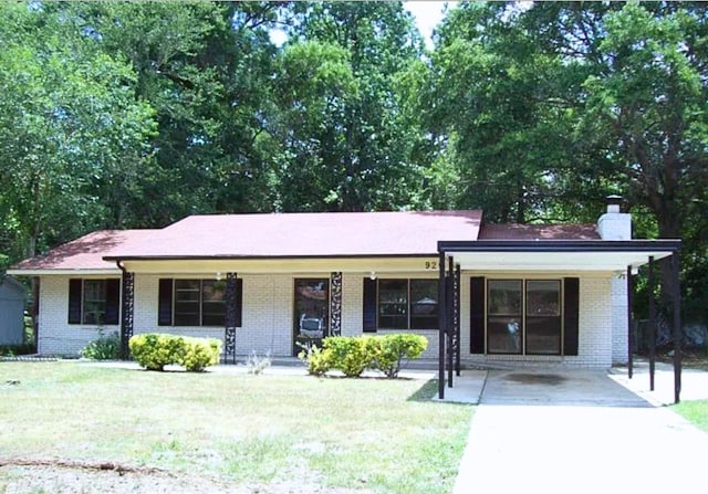 920 Ashland Ave, Columbus, GA 31907 - ranch-style home with a chimney, brick siding, covered porch, and a front yard