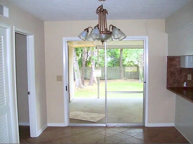 920 Ashland Ave, Columbus, GA 31907 - doorway with a chandelier and tile patterned floors