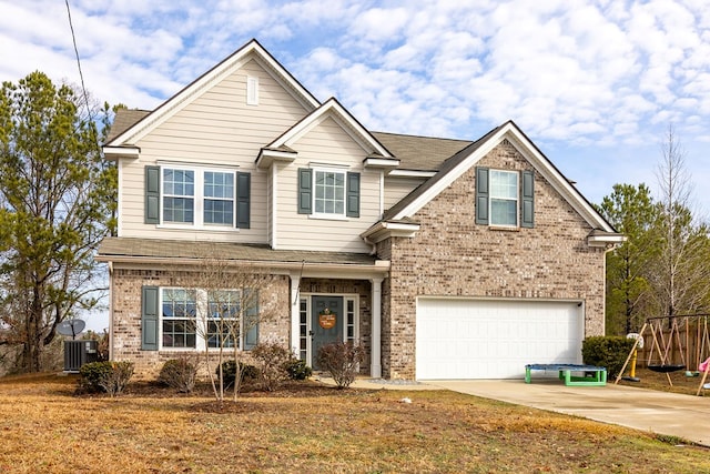 view of front facade with a garage, central AC, and a front lawn