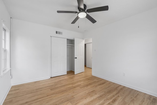 unfurnished bedroom featuring a closet, ceiling fan, and light hardwood / wood-style flooring