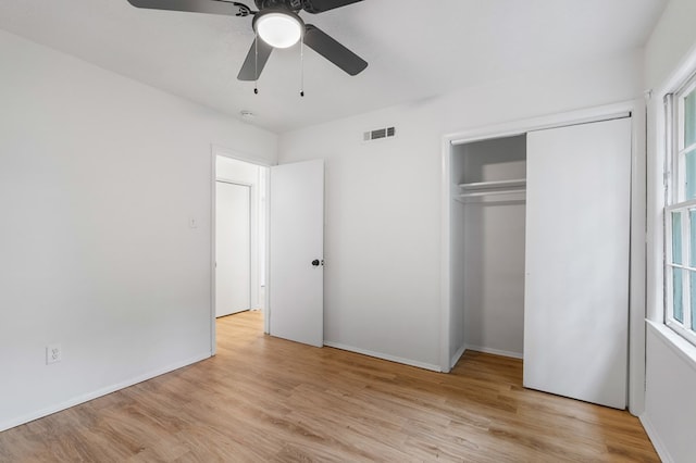 unfurnished bedroom with multiple windows, ceiling fan, and light hardwood / wood-style floors