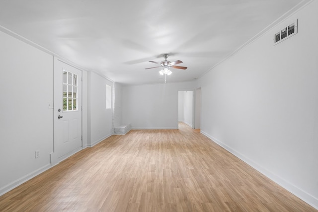 unfurnished living room featuring light wood-type flooring, ceiling fan, and ornamental molding