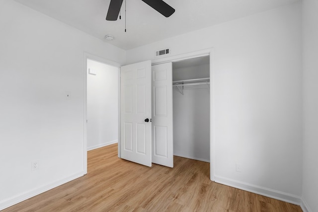 unfurnished bedroom featuring light wood-type flooring, a closet, and ceiling fan