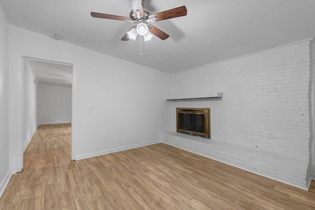 unfurnished living room featuring light hardwood / wood-style floors, a brick fireplace, and ceiling fan