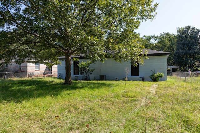 rear view of house featuring central AC