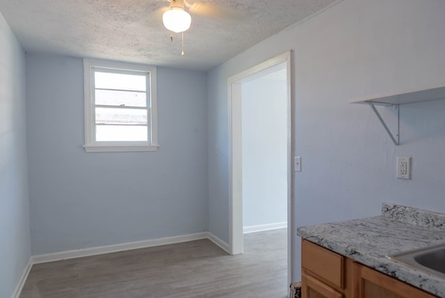 interior space with light hardwood / wood-style flooring and a textured ceiling