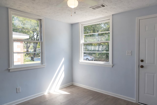 empty room featuring hardwood / wood-style floors and a textured ceiling