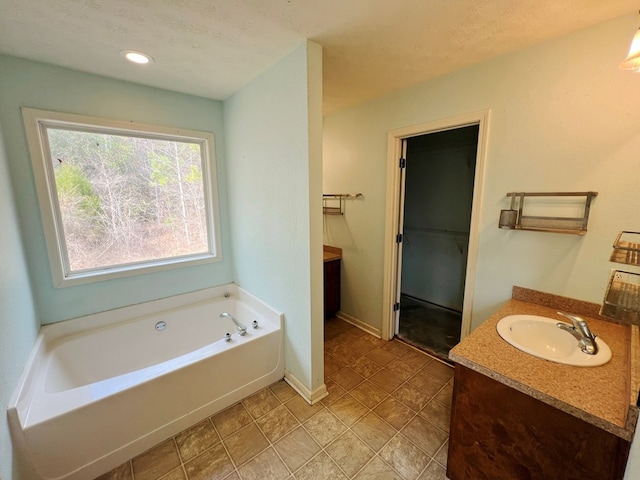 bathroom featuring vanity and a bath